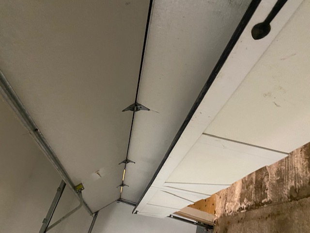 View of garage door roller within its track