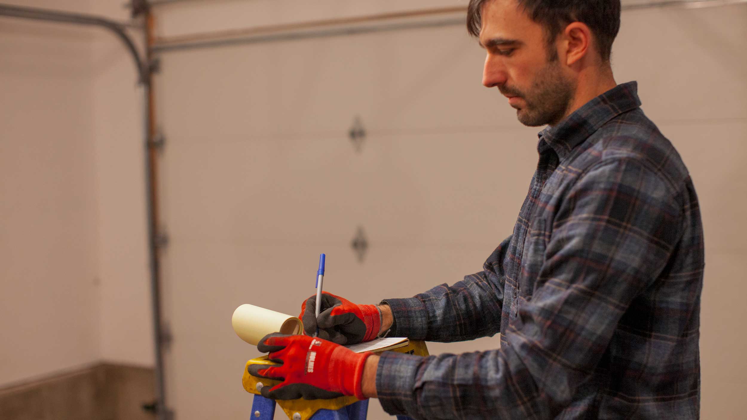 Owner of business repairing garage door opener