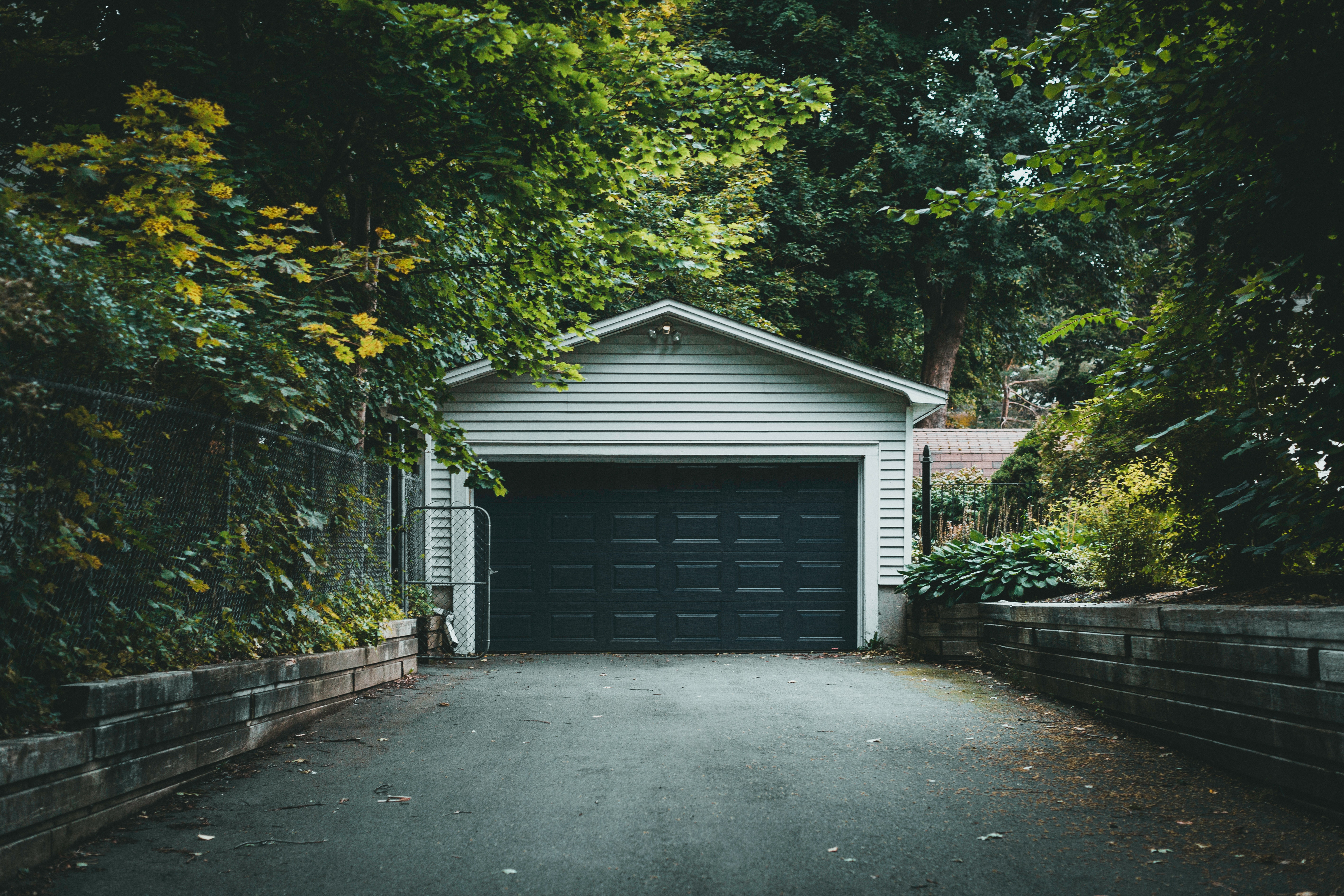 Garage door shut in forested neighborhood